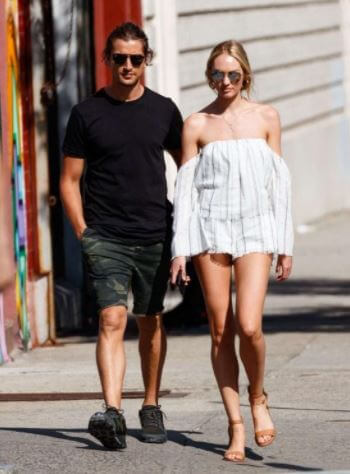 Hermann Nicoli and Candice Swanepoel strolling down the road.
